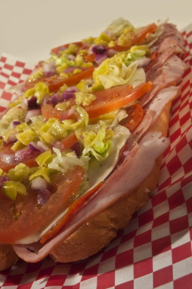 Combo Hero · Stuffed with ham, salami, pepperoni, provolone, lettuce, tomatoes, peppers, onions, dressing and herbs.