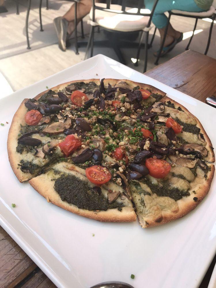 Perfecto Pesto Pizza · Walnut pesto, crimini mushrooms, cherry tomatoes, Kalamata olive, cashew cheese and garlic pecan cheese. Choose a crust