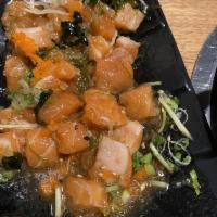 Salmon Poke Bowl · Diced sashimi fish mixed with sesame-soy dressing, lettuce, mixed herbs, sesame seeds and ma...