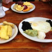 Huevos Rancheros Breakfast · 2 corn tortillas, melted Jack and cheddar cheese, 2 eggs, olives and black beans topped with...