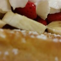 Waffle Fiesta Breakfast · Belgian waffle topped with fresh strawberry, banana powdered sugar and whipped cream.