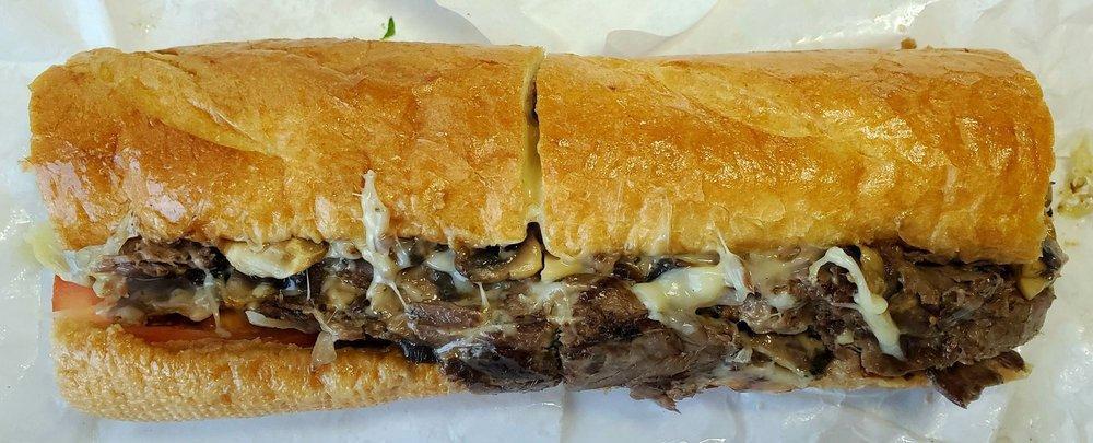 Shroomy Swiss Sandwich · Beef brisket, grilled herb sauteed mushrooms, melted Swiss, lettuce, tomato and mayo on a buttery French baguette.