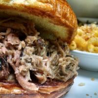 Pulled Pork Sandwich · Slow-smoked pulled pork on a brioche bun, served with house-made chips.