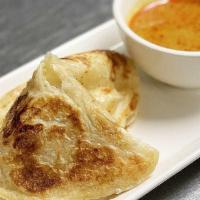 Roti Canai · Flipped fluffy bread served with chicken curry potato dipping.