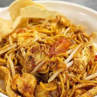 Mee Goreng · Egg noodles with bean sprouts, tofu, tomatoes, eggs, lime, potato and fried shallots with ho...