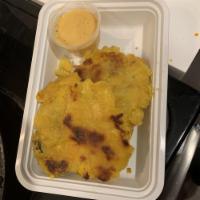 Tostones · Fried green plantains.