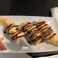 American Dream Roll · Shrimp tempura, avocado, topped with spicy crabmeat, spicy mayo, eel sauce, and cheddar chee...