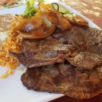 Carne Asada House Special · Grilled juicy marinated steak served with rice, beans, salad, and hand-made tortillas.
