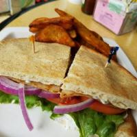 Chicken Gyro Sandwich · Chicken gyro slices, fresh shredded lettuce and tomato, red onion in a warmed Greek pita wit...