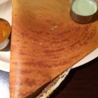 Mysore Masala Dosai · Thin rice crepe with a layer of spicy chutney with potato and onion stuffing. Served with sa...
