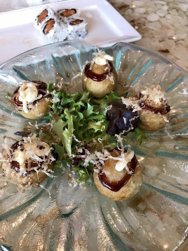 Takoyaki · Five crispy buttered chopped octopus balls topped with Japanese mayo, okonomiyaki sauce & bonito flakes