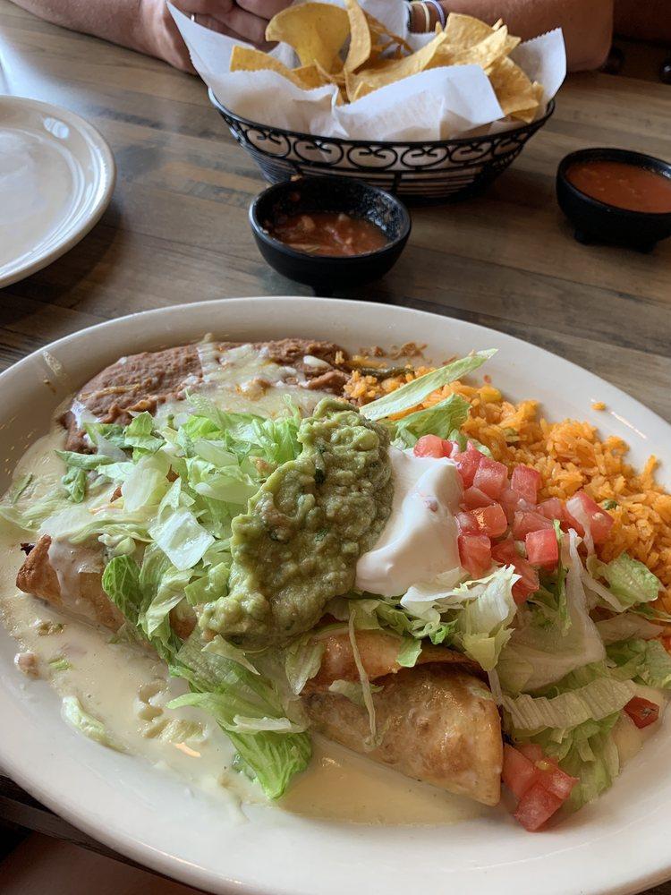 Chimichangas · 2 flour tortillas soft or fried, filled with your choice of protein, topped with cheese sauce, lettuce, sour cream, guacamole, and tomatoes. Served with rice and beans.