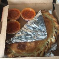 Calzone · Mozzarella cheese wrapped with butter-brushed dough, sprinkled with Parmesan and oregano the...