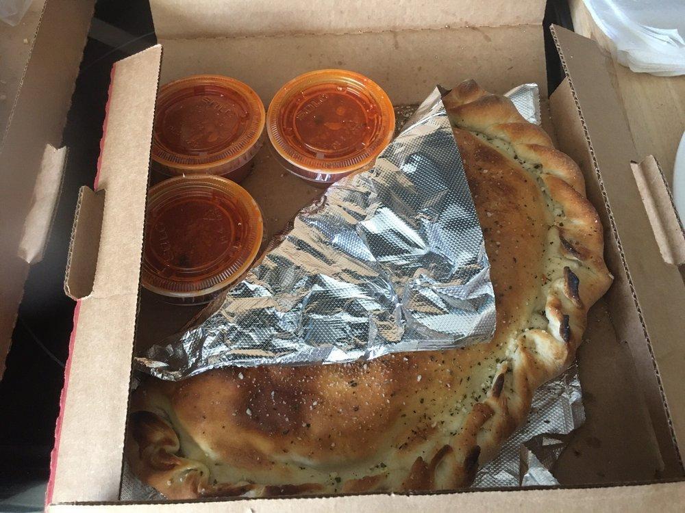 Calzone · Mozzarella cheese wrapped with butter-brushed dough, sprinkled with Parmesan and oregano then baked to perfection. Served with a side of marinara sauce.  Add toppings for an additional charge.