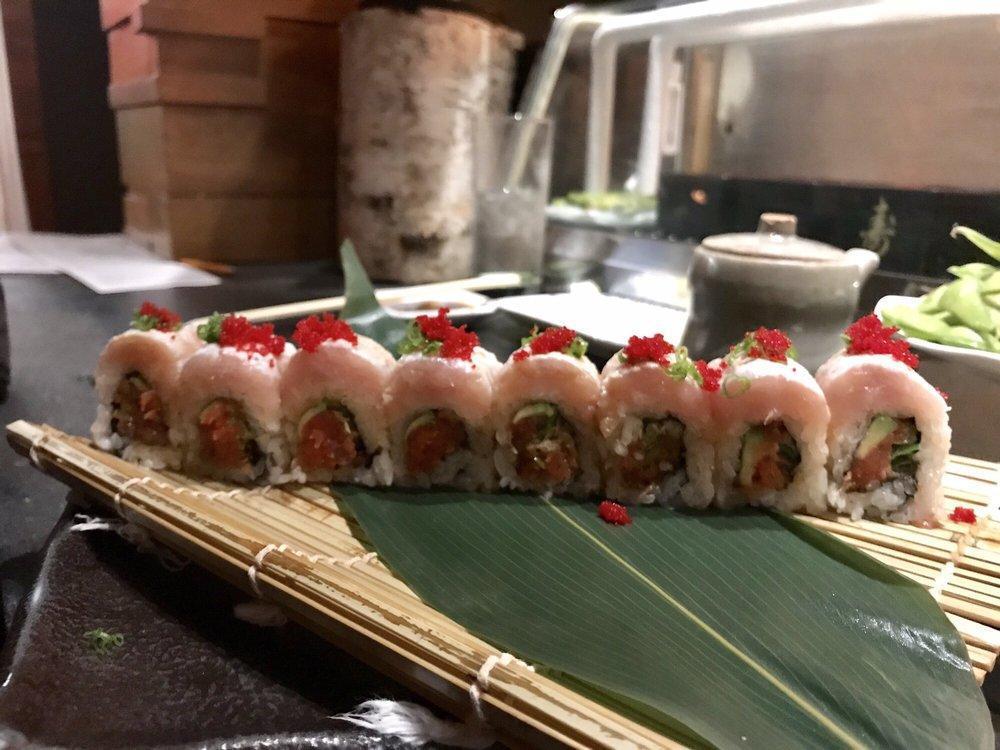 Rip City Roll · spicy tuna, shishito tempura, and avocado topped with seared albacore, green onion, and habanero masago, finished with garlic ginger ponzu