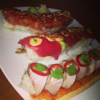 Japanista Roll · spicy tuna, spicy crab salad, and kaiware topped with seared albacore, sweet chili sauce and...