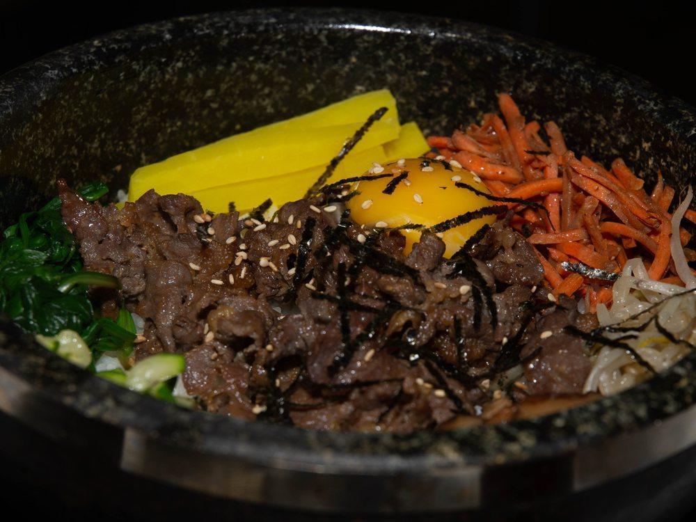 Bibimbap · white rice, Quinoa, Assorted seasonal vegetables and egg with Bonchon red pepper paste on the side. Served in a stone or ceramic bowl.