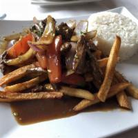 Lomo Saltado · Pepper steak served with rice and french fries.