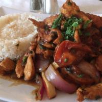 Pollo Saltado · Chicken served with rice and french fries.