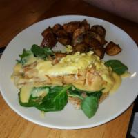 Salmon Benedict · Fresh spinach and sautéed salmon top a honey-wheat English muffin with two over easy eggs an...
