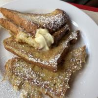Brioche French Toast · 2 thick slices of brioche bread dipped in a vanilla custard served with butter and powdered ...