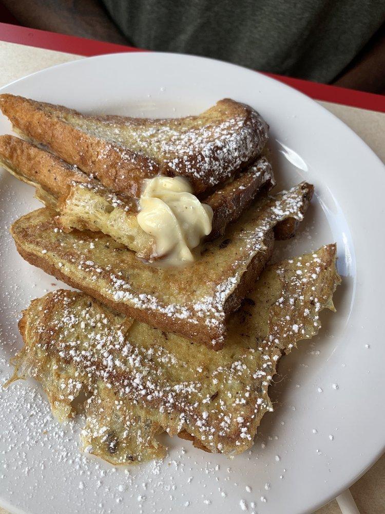 Brioche French Toast · 2 thick slices of brioche bread dipped in a vanilla custard served with butter and powdered sugar.