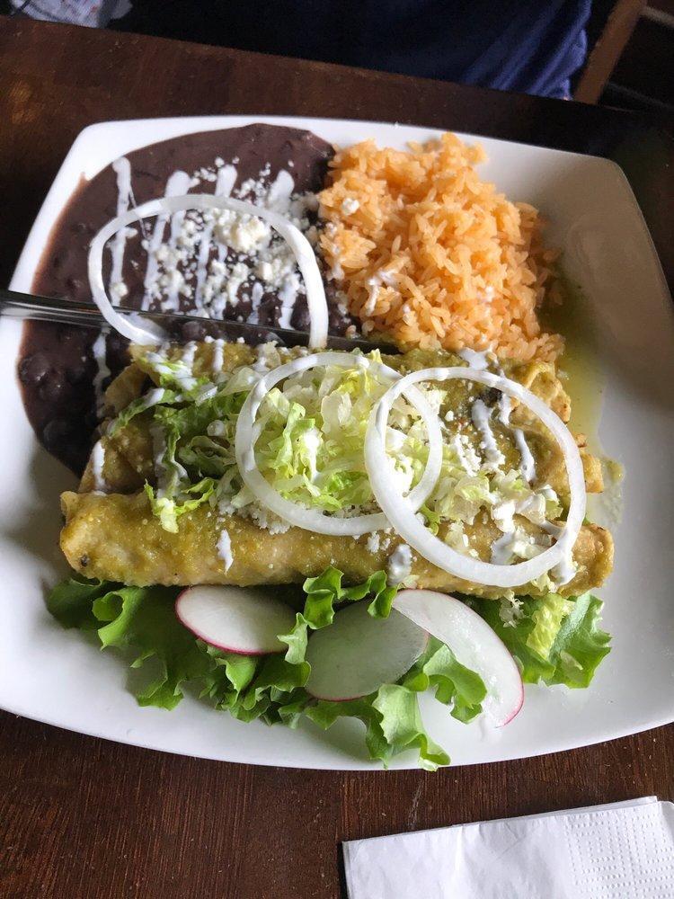 Enchilada · 2 rolled tortillas stuffed with your choice of meat bathed with your choice tomatillo or tomato sauce. Topped with lettuce, crema and queso. Served with rice and beans.