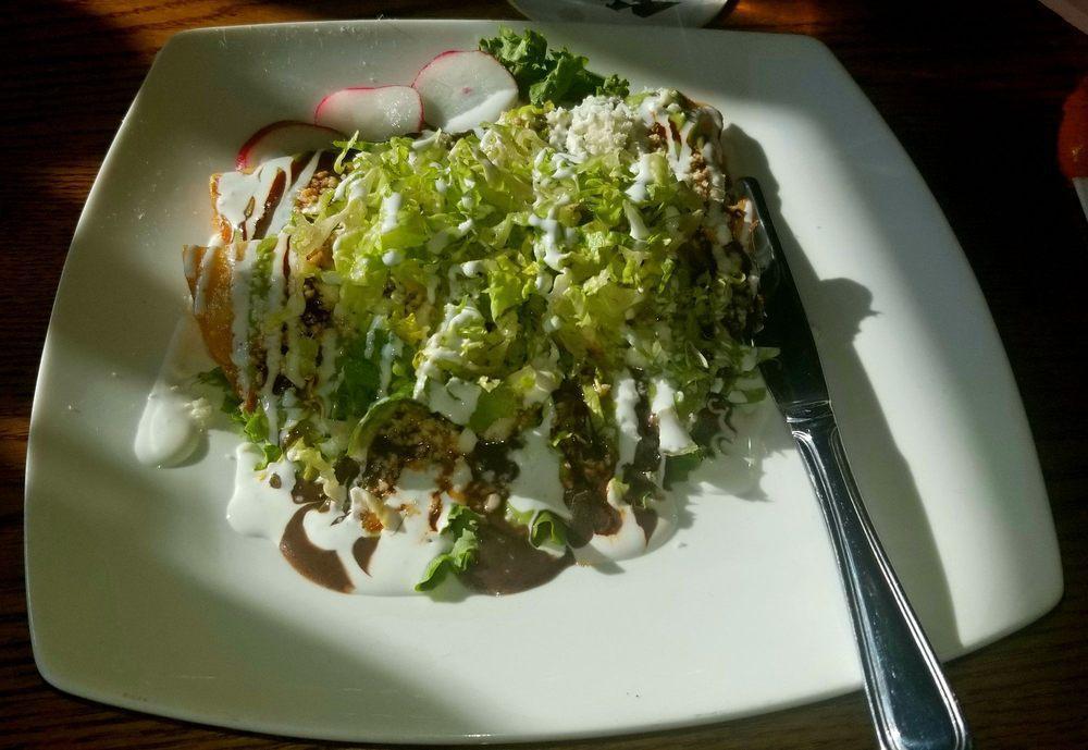 Quesadillas Fritas · Corn tortilla stuffed with cheese and deep fried. Topped with black bean sauce, salsa, cream, and queso fresco.