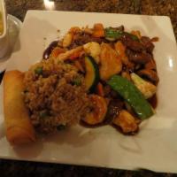 Happy Family · White meat chicken, beef and shrimp stir-fried with assorted vegetables in brown sauce. Serv...