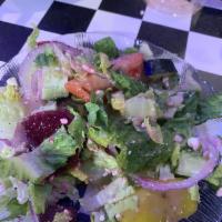 Greek Salad · Tossed garden greens topped with feta cheese, red onions, tomatoes, Kalamata olives, beet sl...