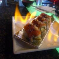 911 Roll · Calamari, green chili tempura, avocado, cucumber and cream cheese topped with salmon, tuna, ...