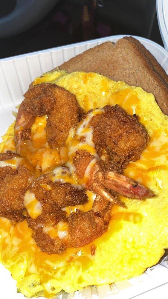 Open Face Shrimp Omelet · Fried Shrimps, Red and Green Peppers, Onions, Cheddar Cheese, with Home-fries and Toast