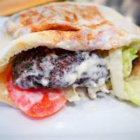 Kefta Kabob · Charcoal grilled ground lamb patties with grilled tomatoes, served on a bed of rice with sal...