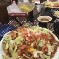 Indian Taco · Fry bread topped with whole beans, melted cheese, lettuce, tomato, onions and red or green c...