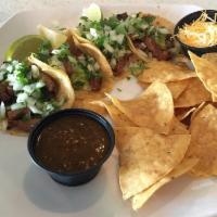 Street Tacos · 4 TJ style tacos, guacamole, cilantro, onion. Choice of carnitas, pollo asado or carne asada.