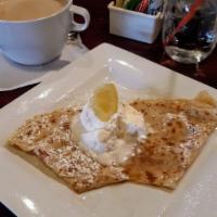 Lemon Zest Crepe · In house made lemon glaze, raw sugar and butter, topped with powdered sugar and side of whip...