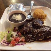 Mole Poblano · Chicken leg and thigh, beans, rice and tortillas. Served with side of beans rice and tortill...