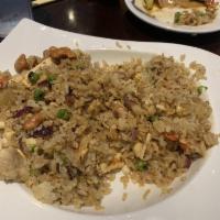 Pineapple Fried Rice · Stir-fried with sweet onions, pineapple chunks and egg topped with cashew nuts, peas and car...