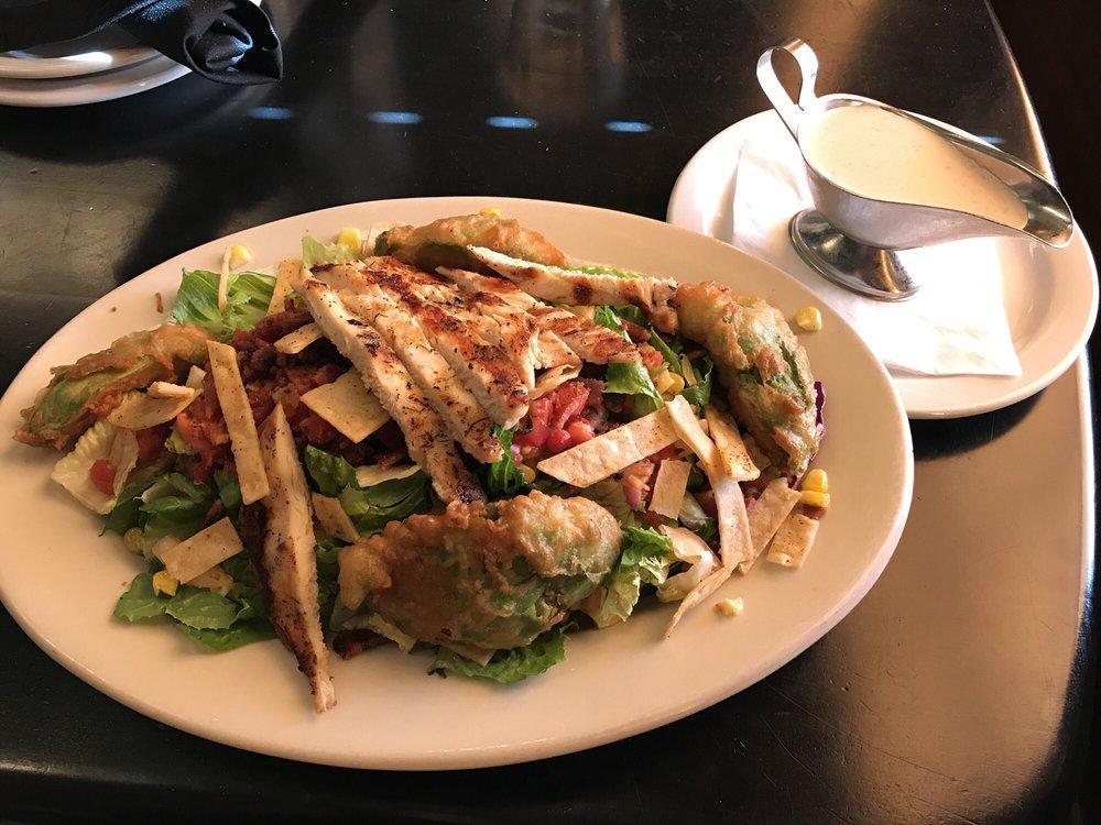 Santa Fe Fried Avocado Salad · Mixed greens, roasted corn, pico de gallo, fried avocados, tortilla strips, and chipotle buttermilk ranch dressing. Add protein for an additional charge.