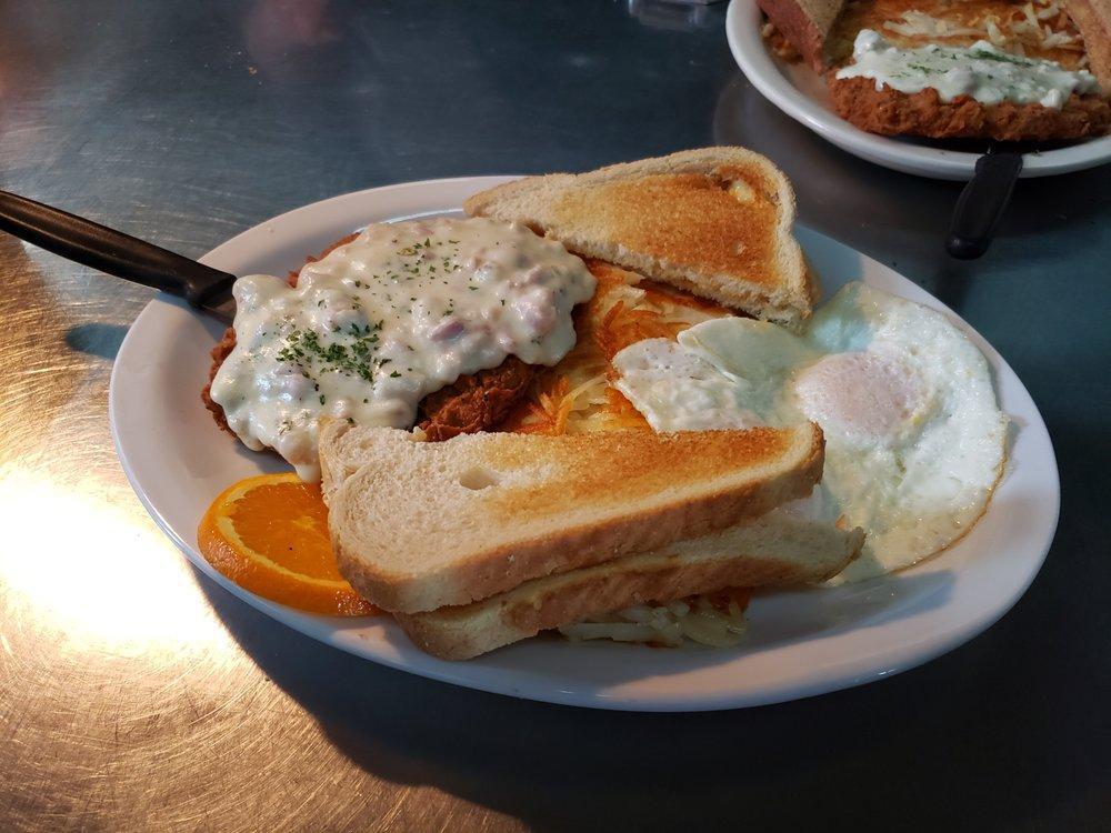 Chicken Fried Steak · Chicken fried steak with country gravy with 2 eggs and either biscuits and gravy or hashbrowns and toast.