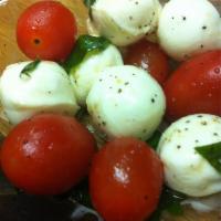 Caprese Salad · Cherry tomatoes, bocconcini, basil and olive oil.
