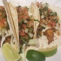Shrimp Tacos · 3 tacos filled with grilled shrimp and coleslaw topped with chipotle sauce.