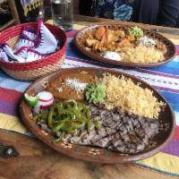 Carne Asada · Marinated Mexican thin steak. Served with rice and your choice of beans.