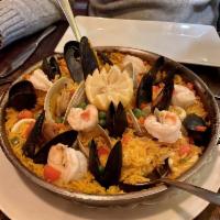 Paella Valenciana · Seafood and meat combination, shrimp, clams, mussels, calamari, chicken chunks  and artisana...