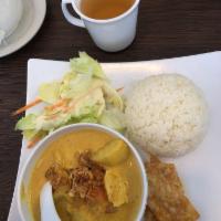 Yellow Curry · Yellow curry paste, with coconut milk, potatoes, carrot, and onion on topped with fried onio...