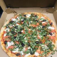 Margarita Pizza · Very light tomato sauce, olive oil, fresh mozzarella, basil and fresh tomatoes.