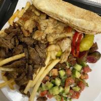 Beef Shawarma Plate · Beef Shawarma over rice and salad served with hummus and pickled veggies. 