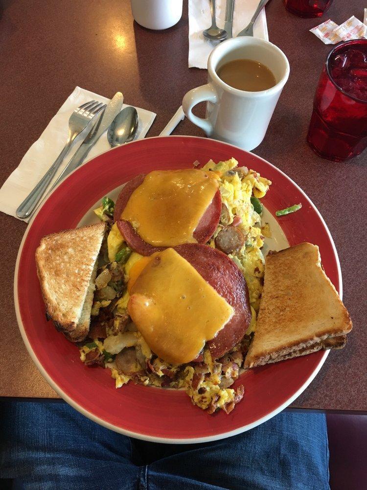 Belly Buster Omelette · Country style with ham, sausage, bacon, mushrooms, onions, peppers, cheese and home fries all mixed together.  Served with toast. 