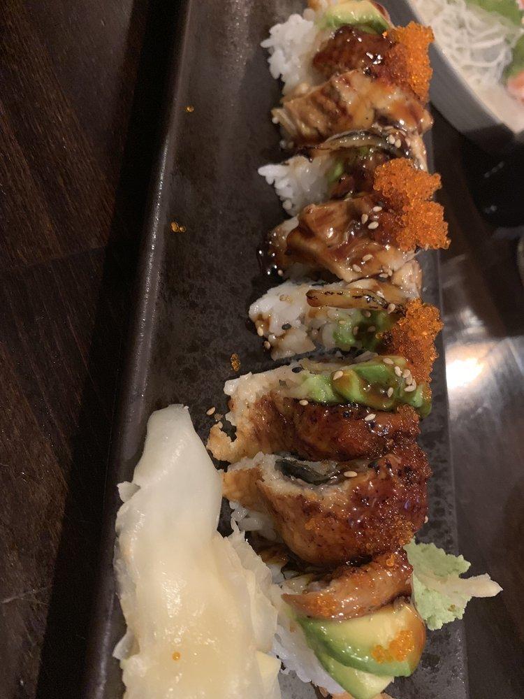 Dragon Roll · Shrimp tempura, cucumber topped with eel, avocado, sesame, tobikos, unagi sauce.