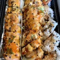 Lion King Roll · Crab meat, avocado, baked salmon on top with spicy mayo, unagi sauce, green onion and tobikos.